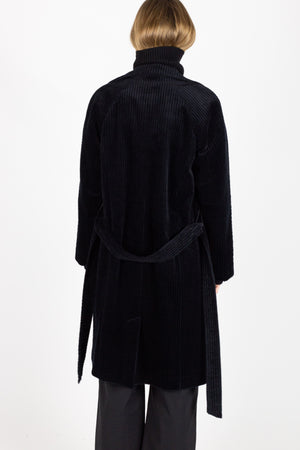 Corduroy coat, black belted.